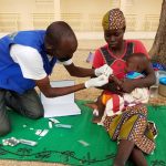 health-worker-providing-curative-services-malaria-cameroon